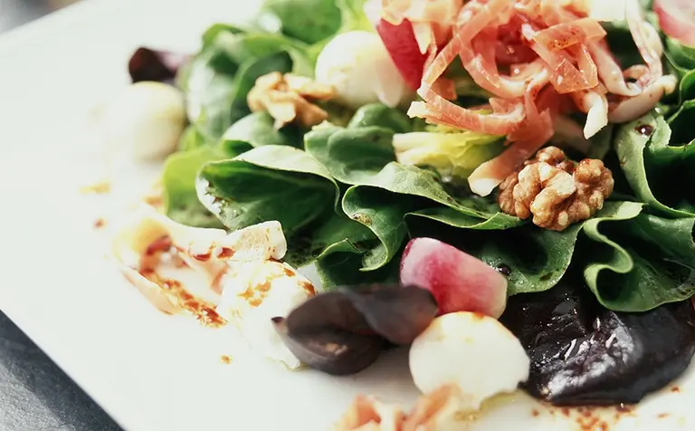 Salade d’automne aux oeufs de caille pochés, noix, raisins, et Jambon cru Aoste professionnel